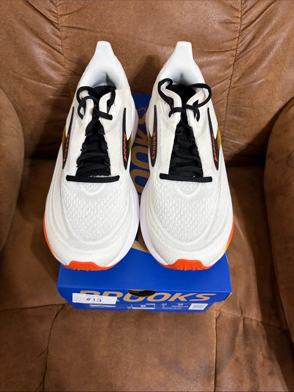 Brooks Revel 9 Men’s Running Shoe in White with Black, Yellow & Orange Accents
